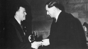 Monochrome photographs of Mr Humphrey Cripps receiving the Ordo Caligulae (a small silver boot mounted on an oak plinth) from the University of Nottingham Students Union to recognise his distinguished service in the interest of students.